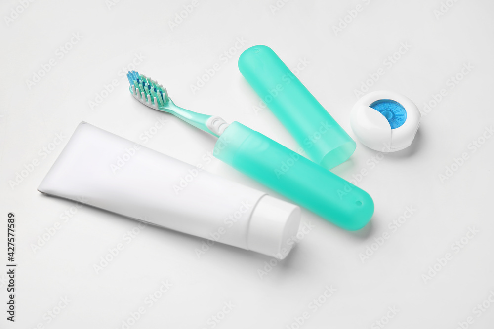 Tooth brush with case, paste and floss on white background Tooth brush with case, paste and floss on white background