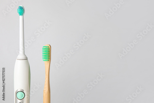 Different tooth brushes on white background