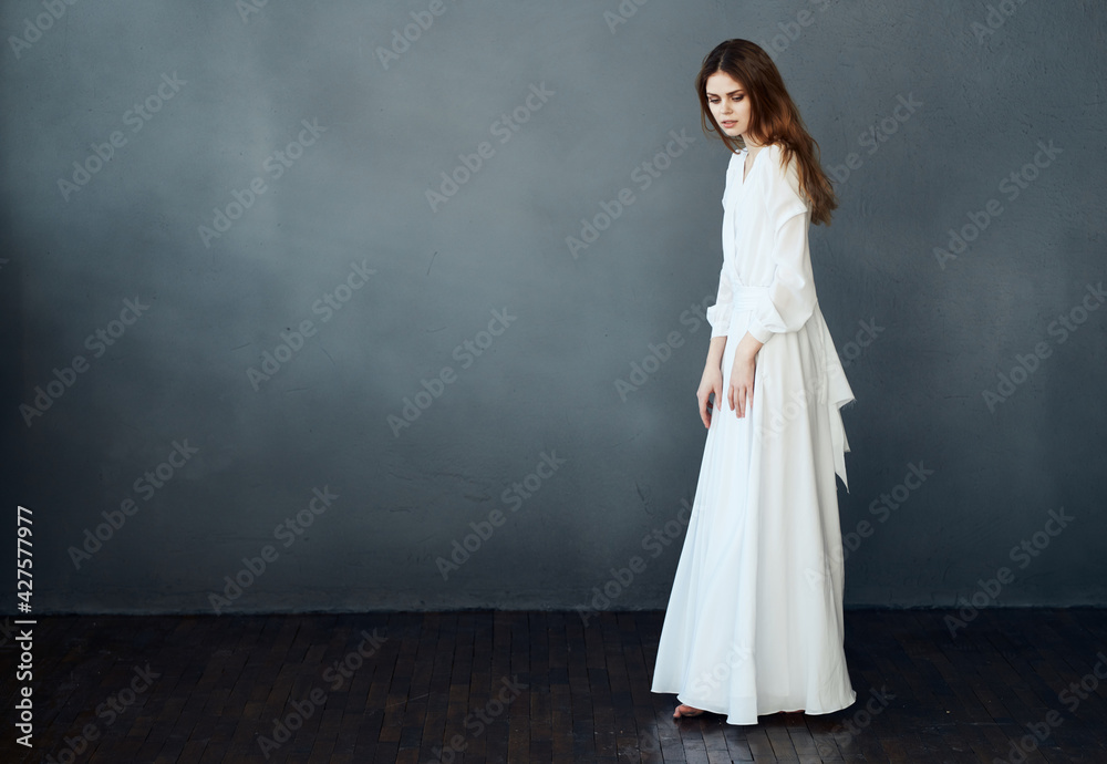 Woman in white dress on gray background red hair model romance Copy Space Woman in white dress on gray background red hair model romance Copy Space