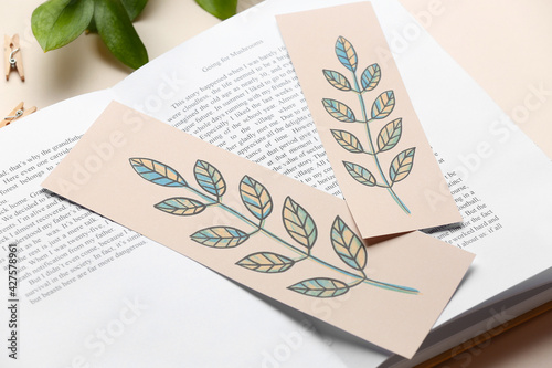 Book with bookmarks on light background, closeup