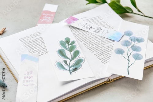 Book with bookmarks on ligh...