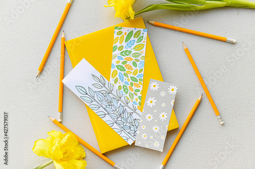 Book with bookmarks, pencil...