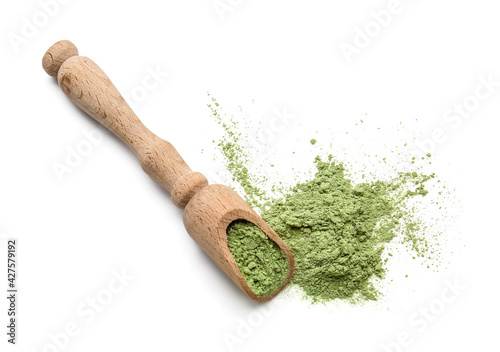 Scoop with powdered matcha tea on white background