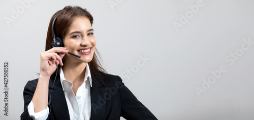 Attractive business woman in suits and headsets are smiling while working isolate on white background. Customer service assistant working in office. VOIP Helpdesk headset