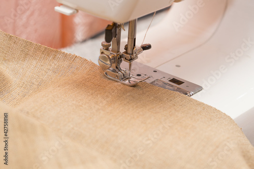 A sewing machine and a piece of fabric. Close-up photo. Shallow depth of field.