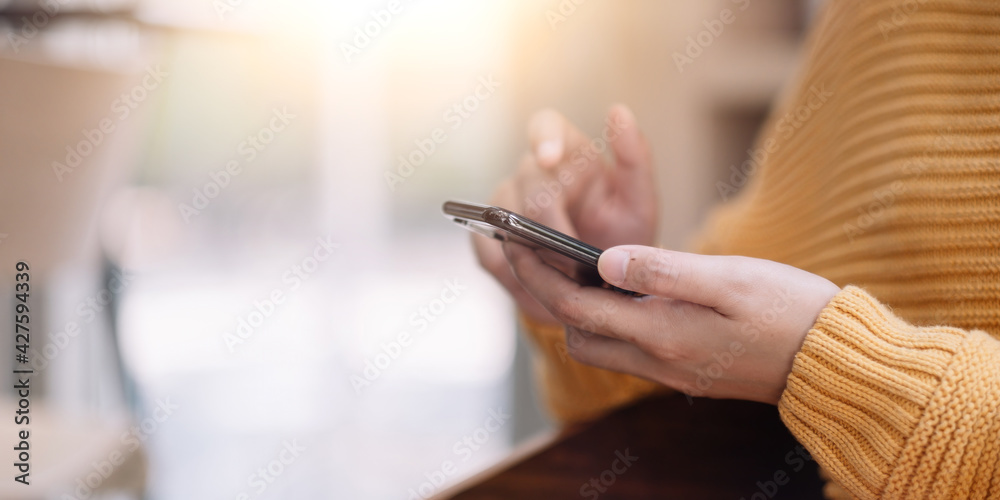 Close up hanf of woman using mobile phone. Isolation at home Close up hanf of woman using mobile phone. Isolation at home