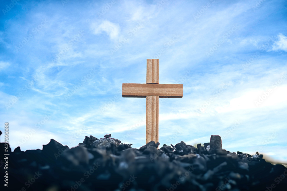Wooden cross standing on charcoal, Jesus cross, Easter, resurrection concept, symbol of sacrifice, Religion concept.