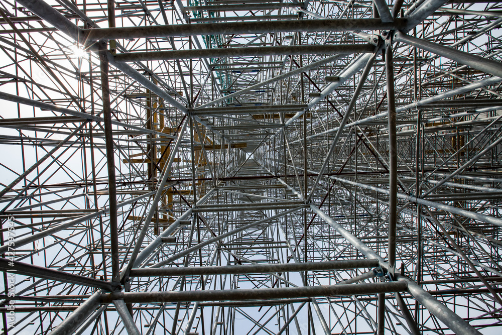 Construction of modern high-rise ski-jump in Shchuchinsk city, Kazakhstan. Close-up a metal scaffoldings in perspective.