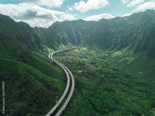 Aerial view of Oahu highway between the mountain of Hawaii. Road to Heaven.
