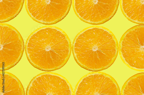 Orange Fruit slice on yellow Background. Healthy food lifestile. Food background. Applicable for fruit juice advertising. Frame, border. Copy space for text. Summer concept.