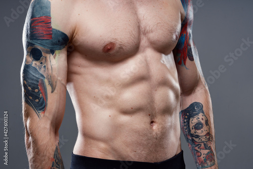 man with pumped up press tattoo on his arms cropped view of workout