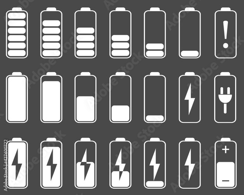 A set of battery charging icons in white on a dark background.Battery charging indicator icons.Power level and battery charge.Flat vector illustration.