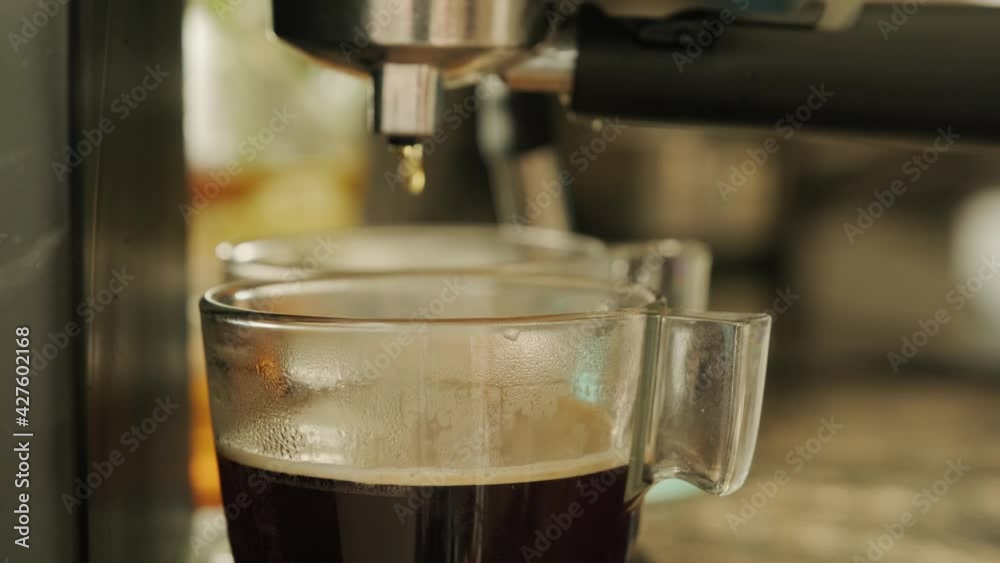 coffee is poured from the coffee machine coffee is poured from the coffee machine