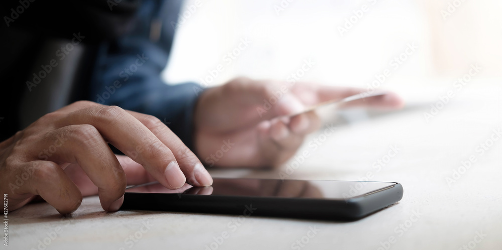 Online payment,Man's hands holding a credit card and using smart phone for online shopping Online payment,Man's hands holding a credit card and using smart phone for online shopping