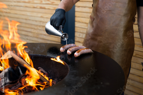 Sausage on Barbeque Smoker Grill. Hot and smoked sausage. Food Festival