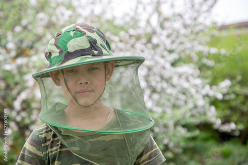 Boy in a hat with a mosquito net