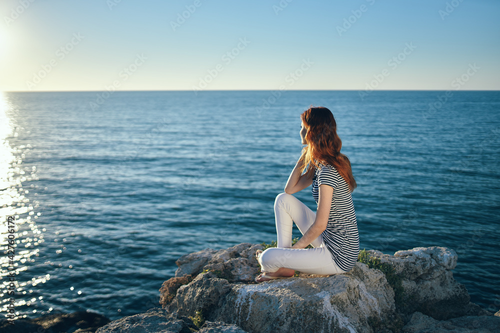 woman on the sea in the mountains in the evening at sunset high cliffs mountains woman on the sea in the mountains in the evening at sunset high cliffs mountains