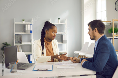 African american woman recruiter, financial adviser, insurer giving last recommendation to employee, client, buyer before signing contract agreement in office. Business meeting, negotiation, interview