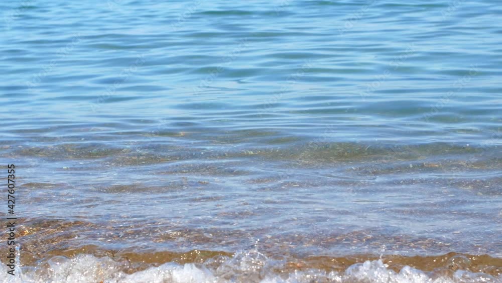 The water washes the golden sand under the rays of the sun. 4K Video close-up of sea, ocean, and golden sand on a bright sunny summer day.
The water washes the golden sand under the rays of the sun. 4K Video close-up of sea, ocean, and golden sand on a bright sunny summer day.