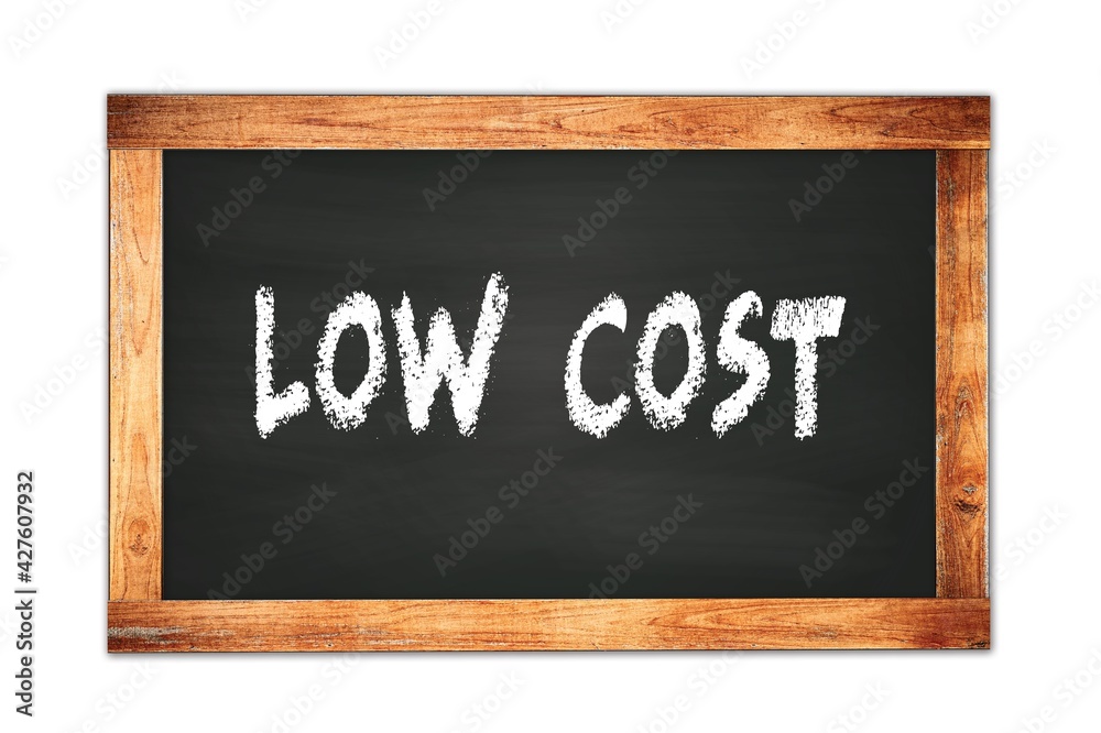 LOW COST text written on wooden frame school blackboard. LOW COST text written on wooden frame school blackboard.