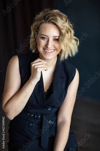 beautiful girl in a black dress in harsh sunlight