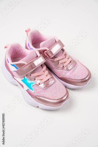 pink shiny sneakers. Stylish fashionable bright shoes for girls' children. Shoe store.