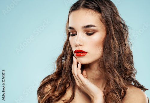 Sexy brunette woman red lips model blue background