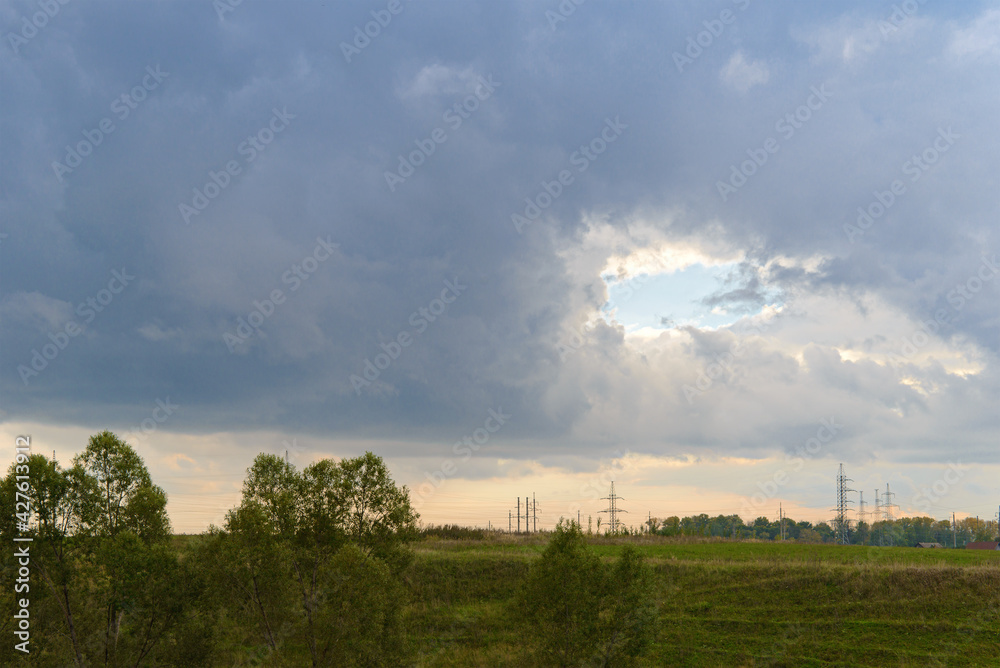 Landscape with a hole in the sky covered with clouds Landscape with a hole in the sky covered with clouds