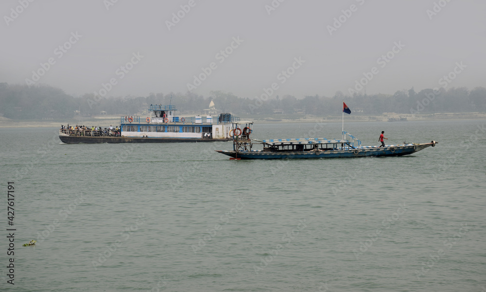 Boats on the move at river Brahmaputra in Assam, India Boats on the move at river Brahmaputra in Assam, India