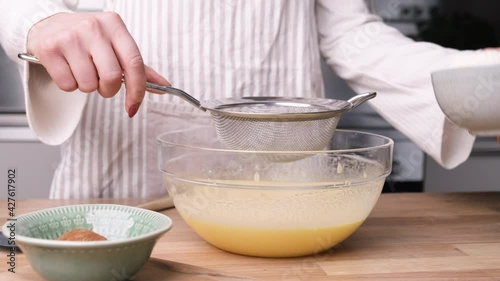 Wallpaper Mural Woman Putting Flour Using Strainer And Pouring It To The Beaten Eggs In Baking Carrot Cake - medium shot, close up Torontodigital.ca