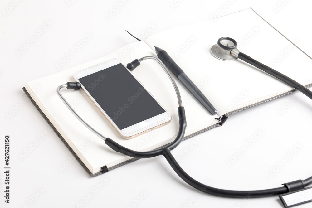 Black stethoscope lying on the diary, medicine. Black stethoscope lying on the diary, medicine.