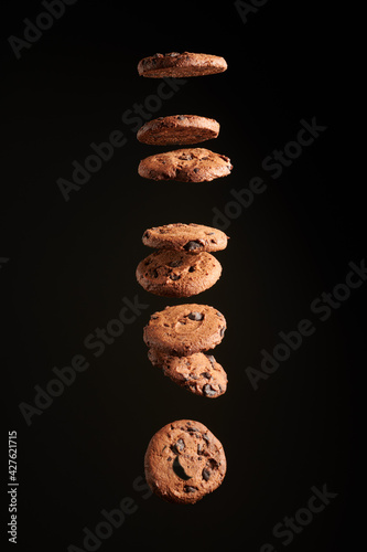 cookies in the air on a black background. cookies with chocolate crumbs levitating on a black background