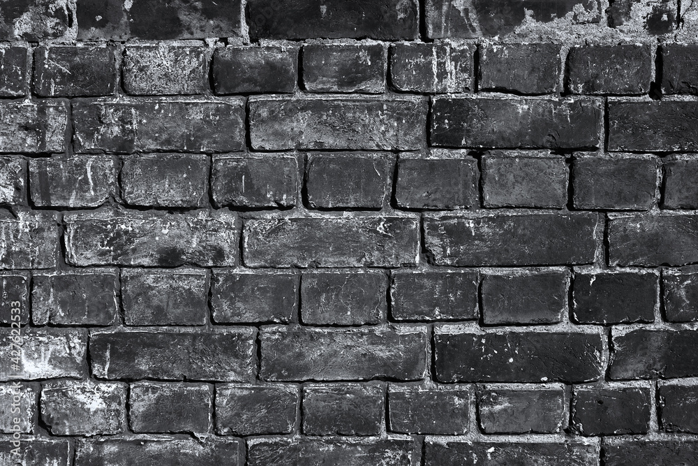 Fototapeta premium Dark brick wall with soot and grime. Real old building facade background for decor and design posters and banners