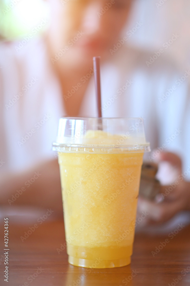Orange juice shakes on a wooden table in a coffee shop. Orange juice shakes on a wooden table in a coffee shop.