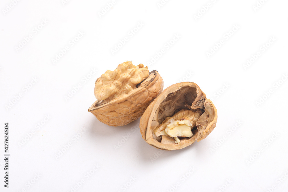 Walnuts and cracked walnut, isolated on white background Walnuts and cracked walnut, isolated on white background