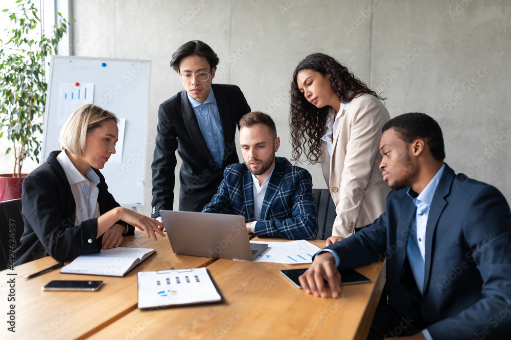 Group Of Multiethnic Business People Working On Laptop In Office Group Of Multiethnic Business People Working On Laptop In Office