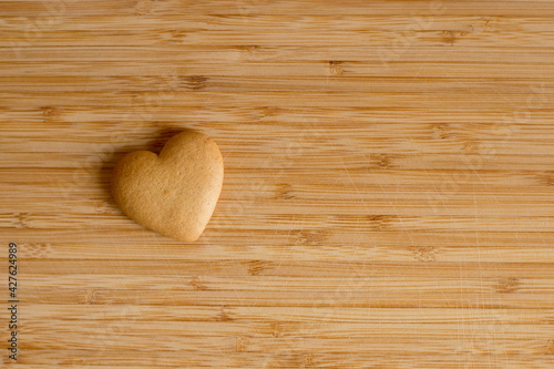 Gingerbread in the form of a heart on a wooden board