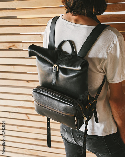 The student wears a black leather backpack. Back view. photo