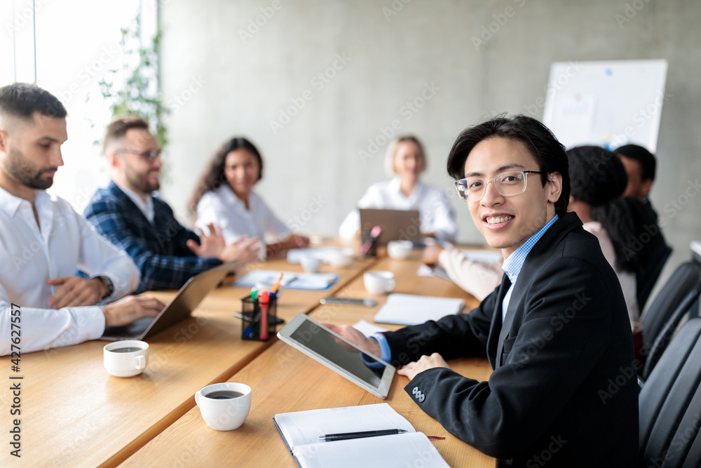 Asian Businessman Using Digital Tablet Attending Corporate Meeting In Office