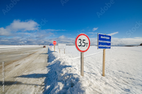 Fototapeta Naklejka Na Ścianę i Meble -  April, 2021 - Kholmogory. Ice road across the Northern Dvina river. Russia, Arkhangelsk region 