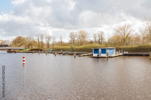 Houseboat in a small port. Vacation on the water in a houseboat. Floating holiday home. Vacation in Northern Germany 