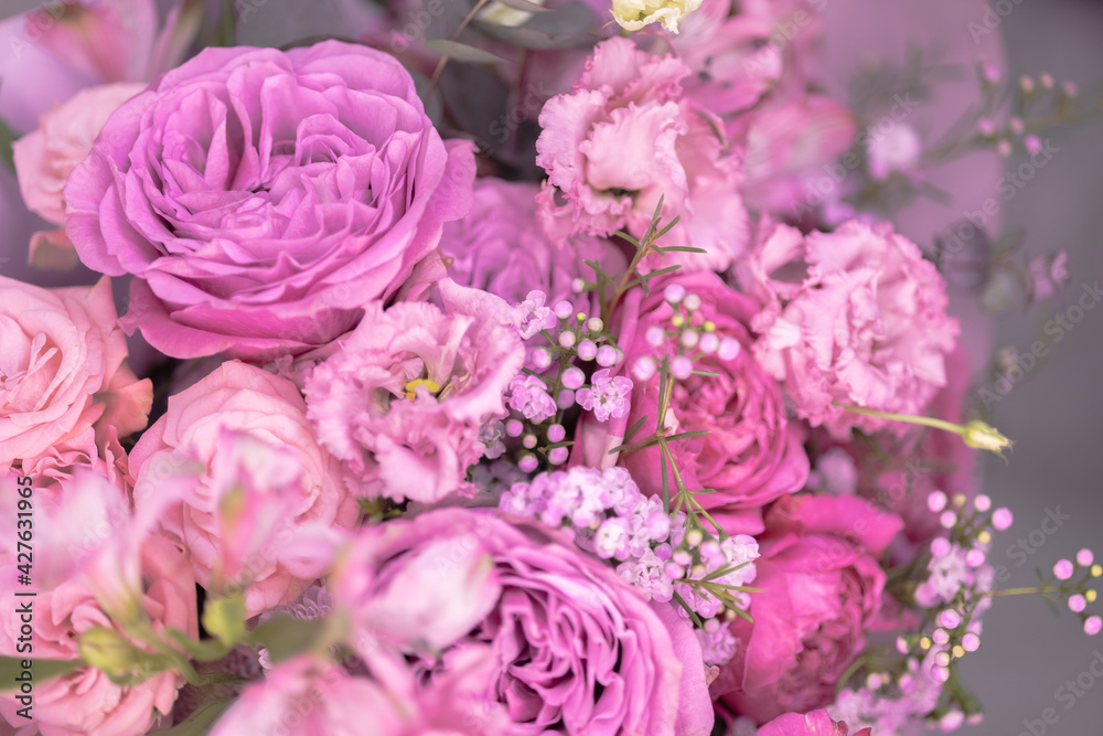 A lush bouquet of light pink, purple cute delicate small roses of different sizes, flowers. Close-up. Macro A lush bouquet of light pink, purple cute delicate small roses of different sizes, flowers. Close-up. Macro