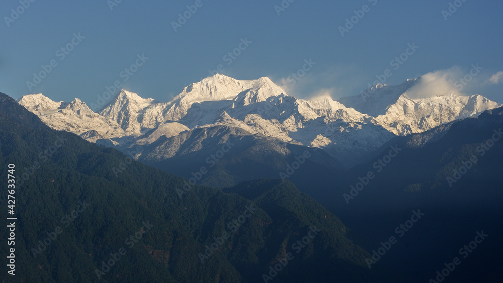 Scenic morning panorama on snow-capped Kangchenjunga mountain in Himalaya range seen from Pelling, Sikkim, India