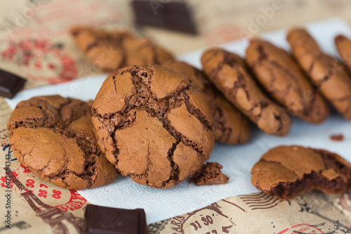 Homemade chocolate cookies brookies on white paper napkin and dark chocolate slices photo