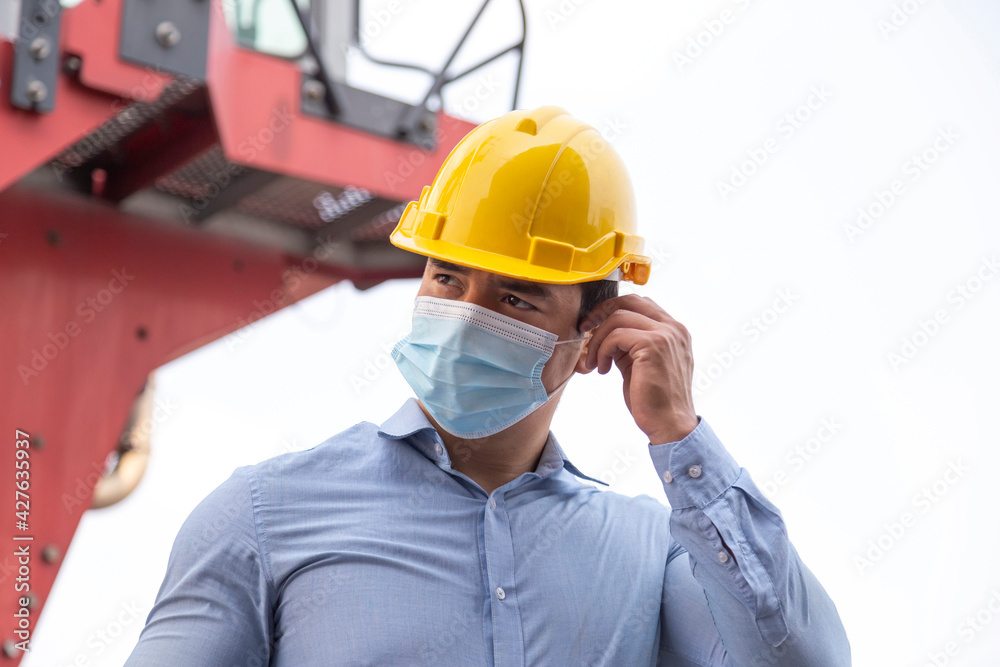 young businessman wearing face mask to protect coronavirus or covid-19 pandemic and pm2.5 bad air pollution from traffic and manufacturing industrials in the city. young businessman wearing face mask to protect coronavirus or covid-19 pandemic and pm2.5 bad air pollution from traffic and manufacturing industrials in the city.