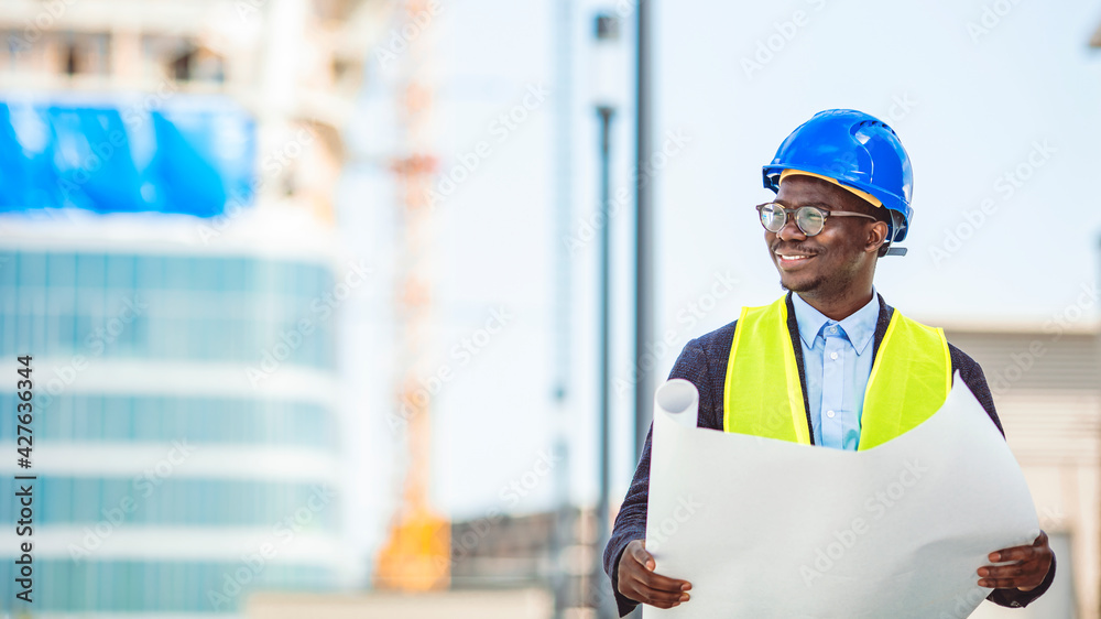 Portrait of satisfied and confident engineer with helmet and news on building site. Close-up portrait of professional architect in hard hat looking away Portrait of satisfied and confident engineer with helmet and news on building site. Close-up portrait of professional architect in hard hat looking away