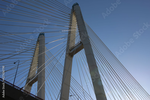 Fototapeta Naklejka Na Ścianę i Meble -  Bottom view of the cable-stayed bridge supports and cable stays against the sky 