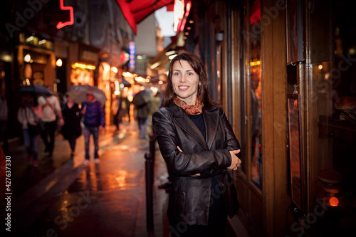 Pretty woman in a black jacket enjoying walking around the city