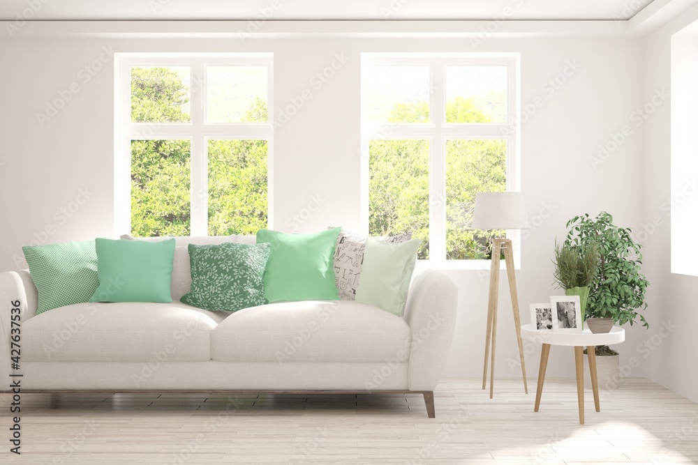 Fototapeta premium White living room with sofa and summer landscape in window. Scandinavian interior design. 3D illustration