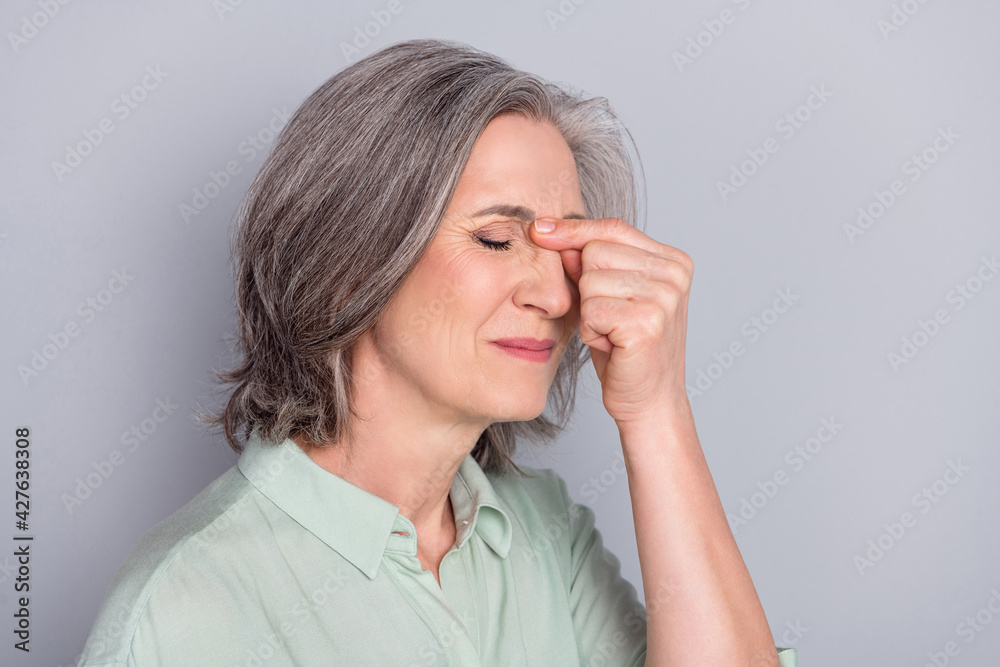 Photo of unhappy upset sad negative mood businesswoman suffer headache overworked isolated on grey color background Photo of unhappy upset sad negative mood businesswoman suffer headache overworked isolated on grey color background